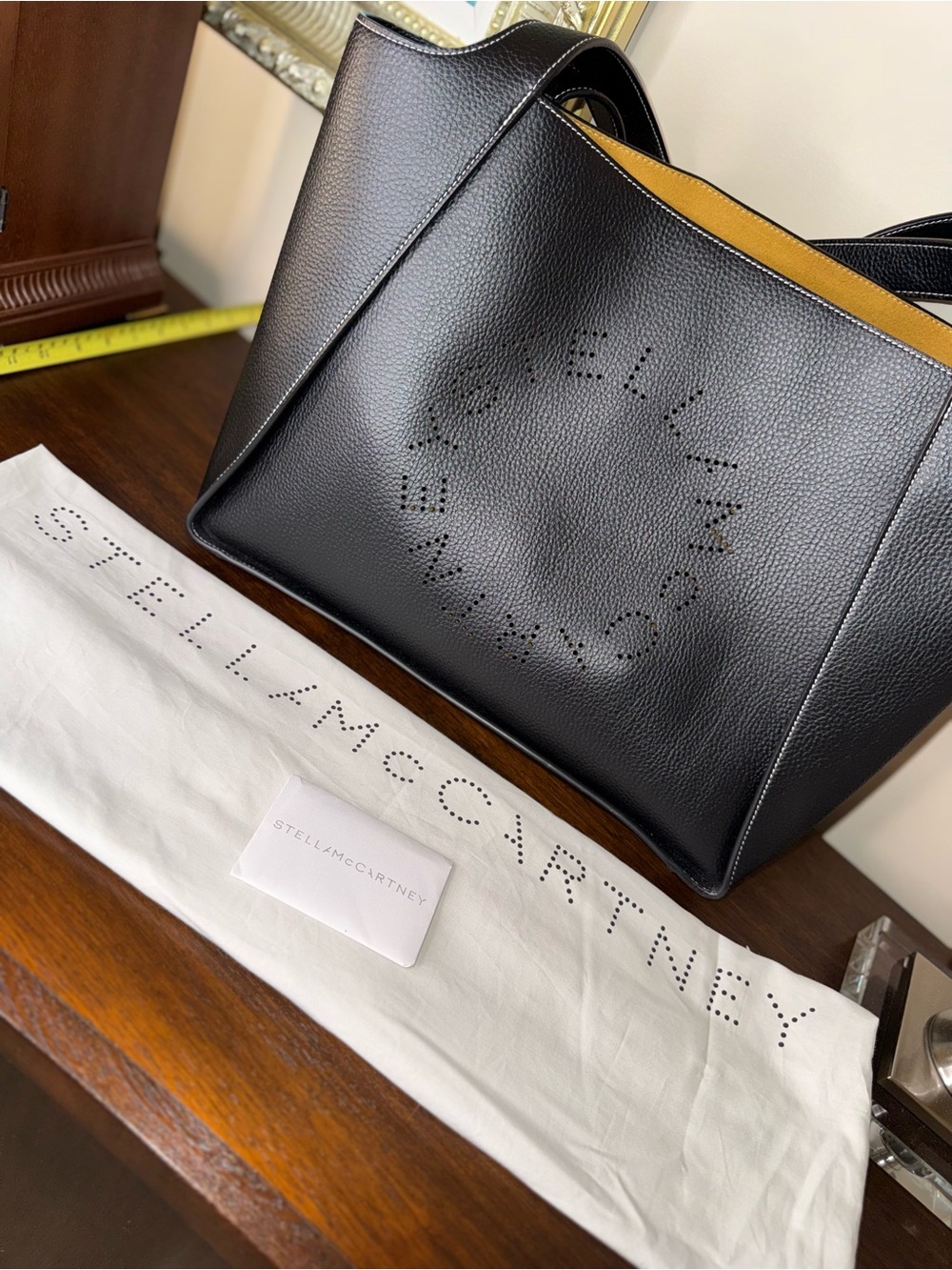 Stella McCartney Black Vegan Leather  Perforated Logo Tote with Mustard Interior